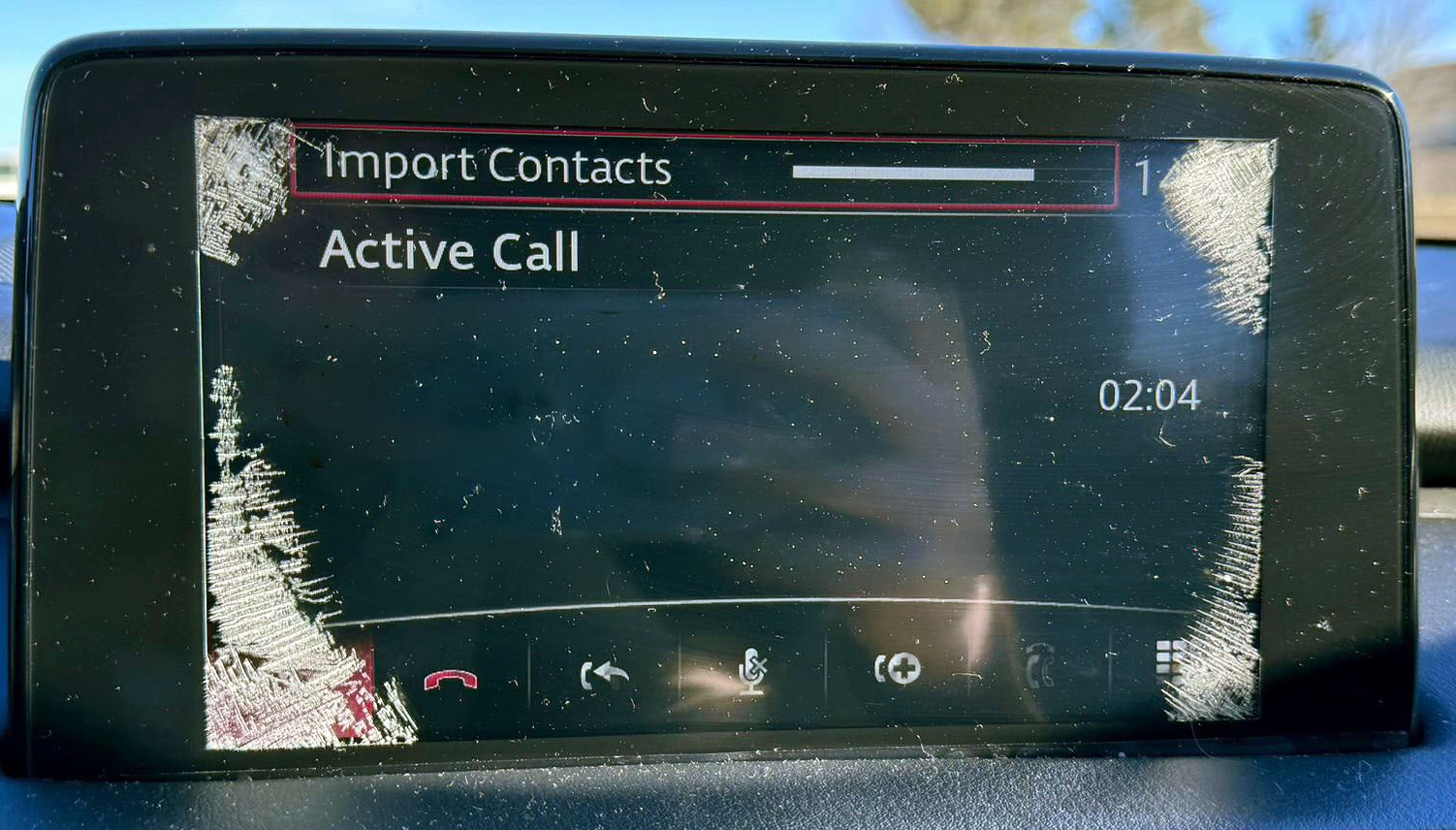 Close-up of spider cracks on a Mazda touchscreen